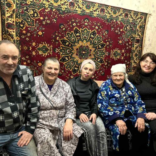 A family sitting on a couch together.