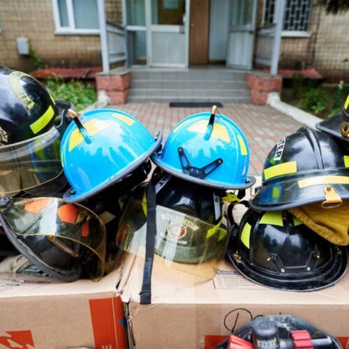 Yellow and blue firefighter hats on top of each other.