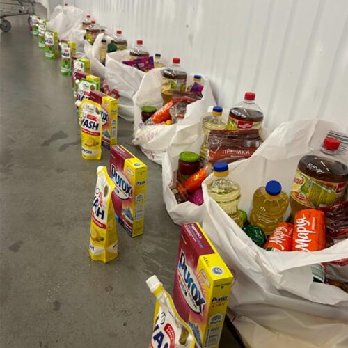 Food supplies in bags on the ground.