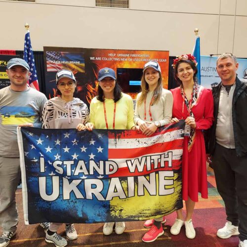 A group of people holding up a flag.