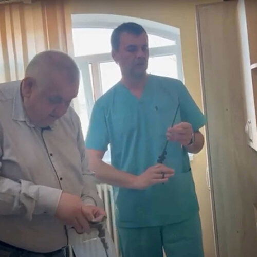 Two medical professionals standing with syringes.