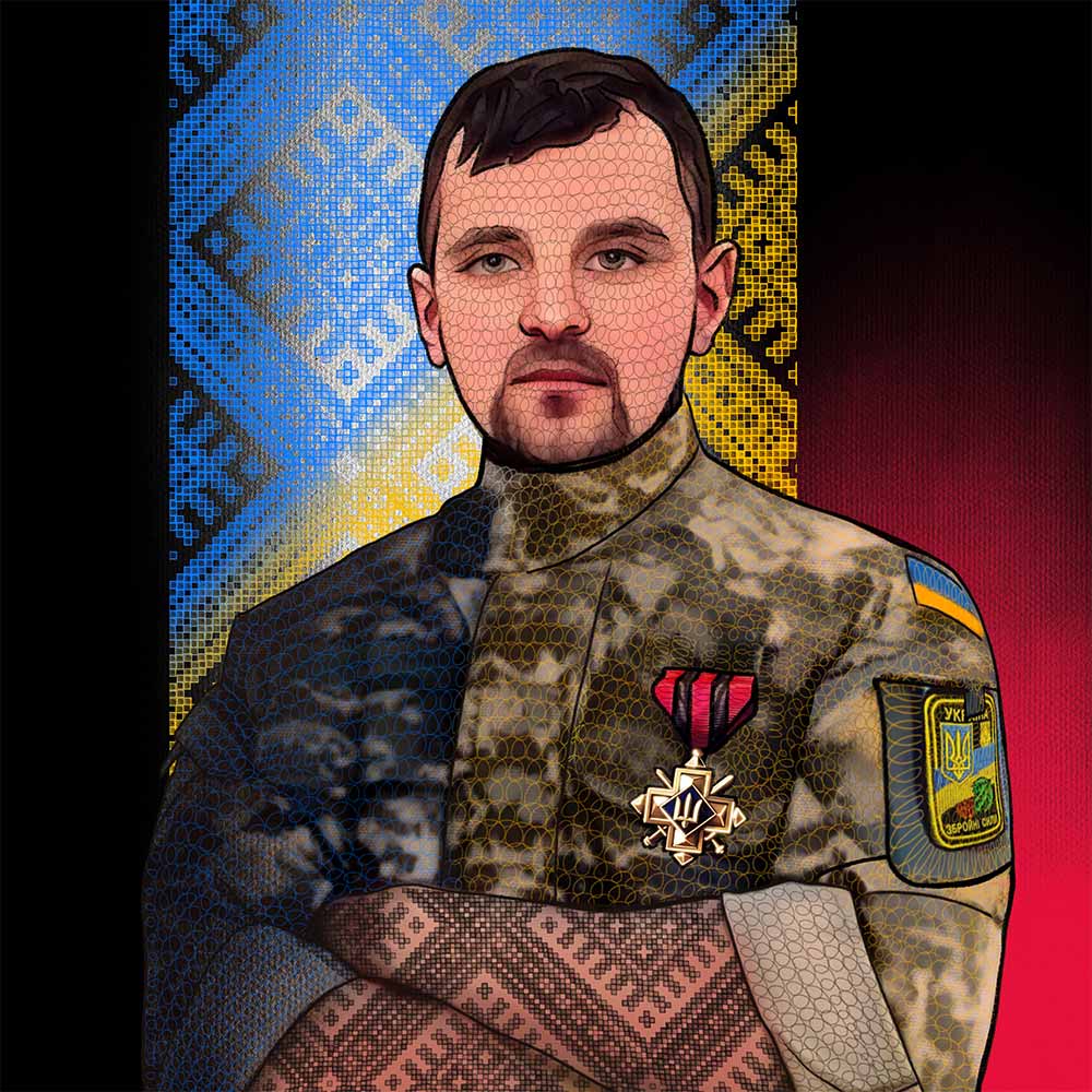 A Ukrainian soldier with embroidery pattern behind him.